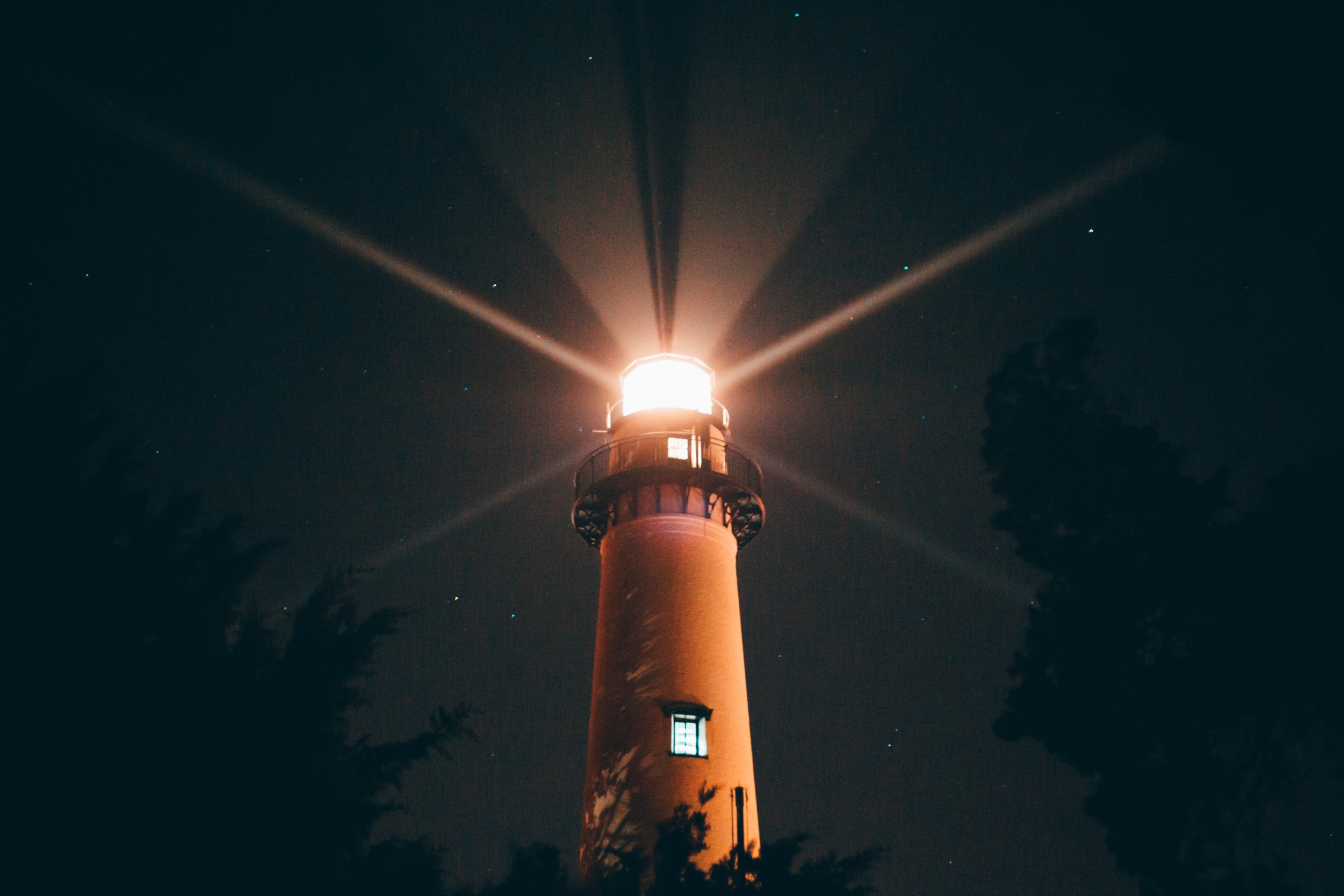 Illuminated Lighthouse at Night